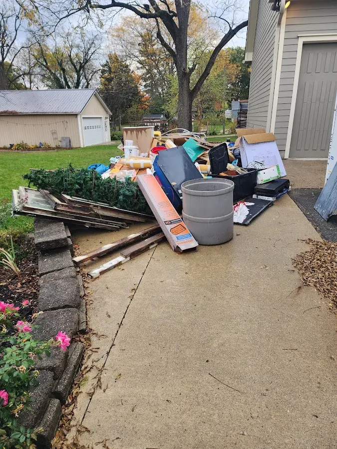 Dumpster being loaded with debris for Estate Cleanout Dumpster Rental in Pittsfield